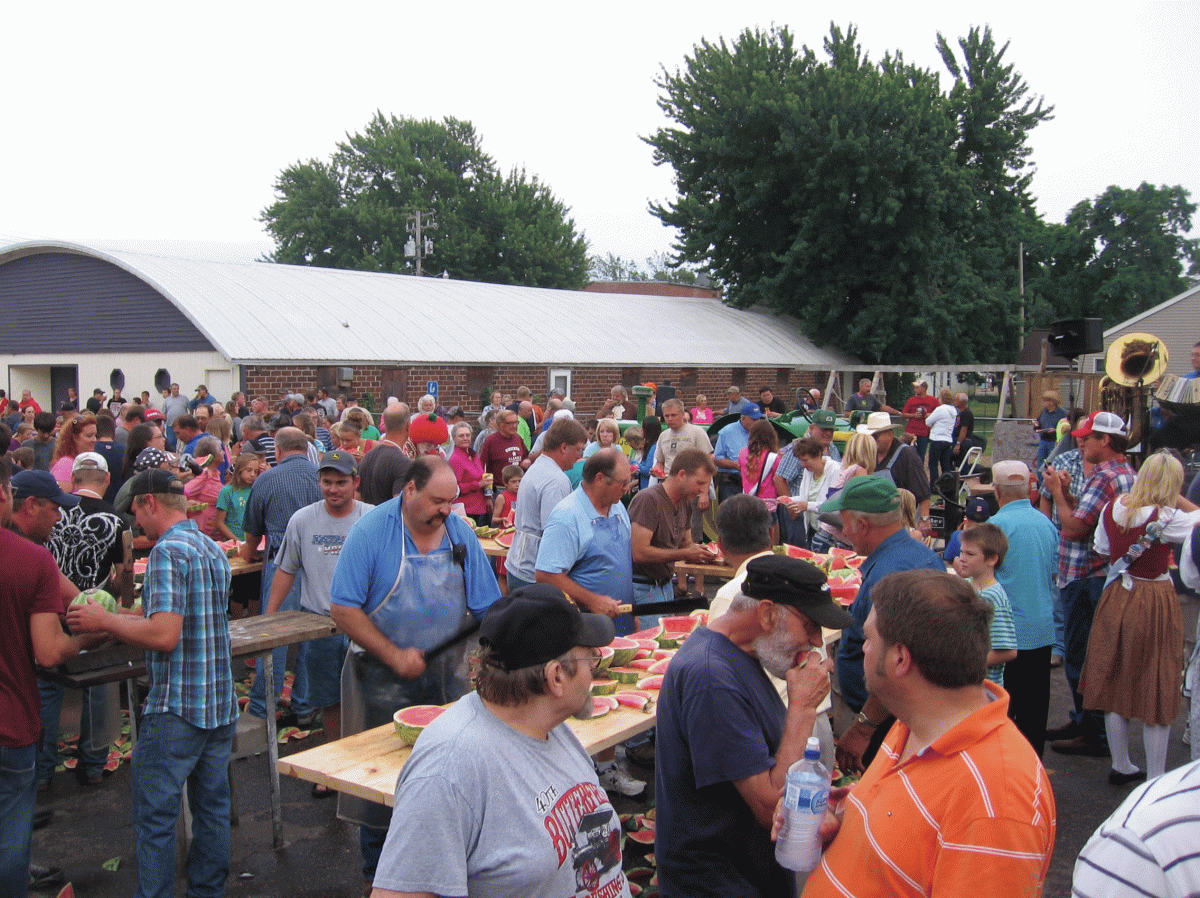 Watermelon Festival, Tables with sliced watermelon and people eating