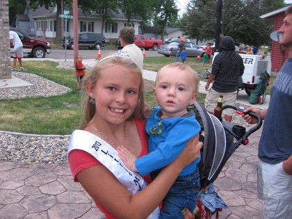 Girl Holding Baby Celebrating City Event